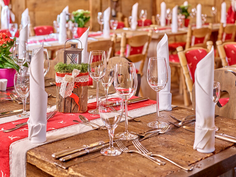 Festlich gedeckter Tisch im Hotel bei Bad Griesbach mit Weingläsern, Blumen und gefalteten Servietten.